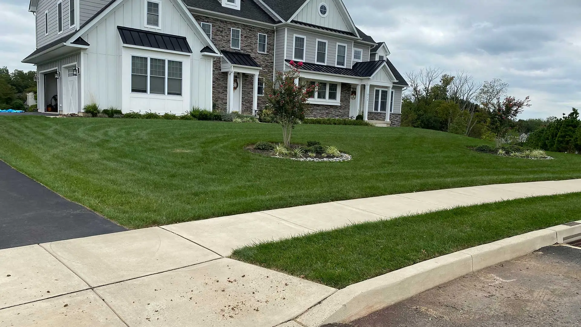 Dark green grass around a home and sidewalk in Pottstown, PA.