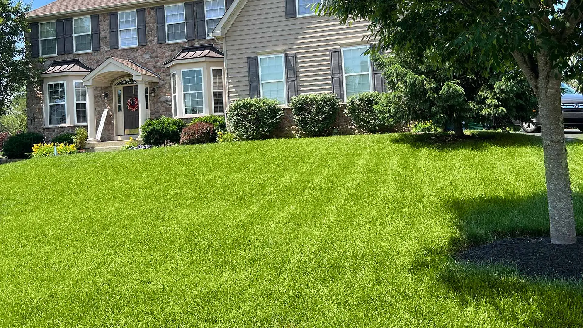 Healthy home lawn with landscaping outside Telford and Souderton, PA.