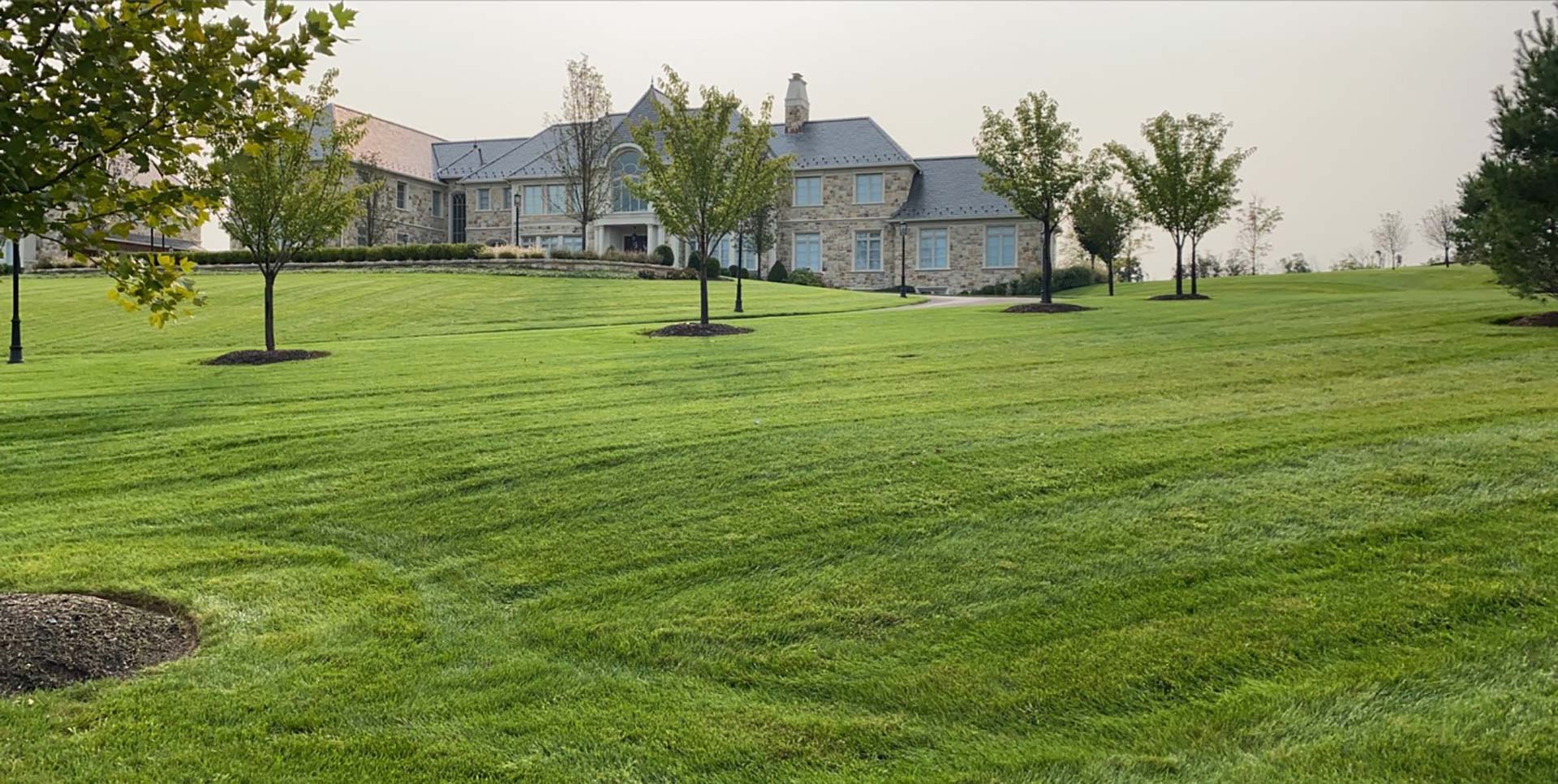 Large green lawn with a home in the distance near Telford, PA.