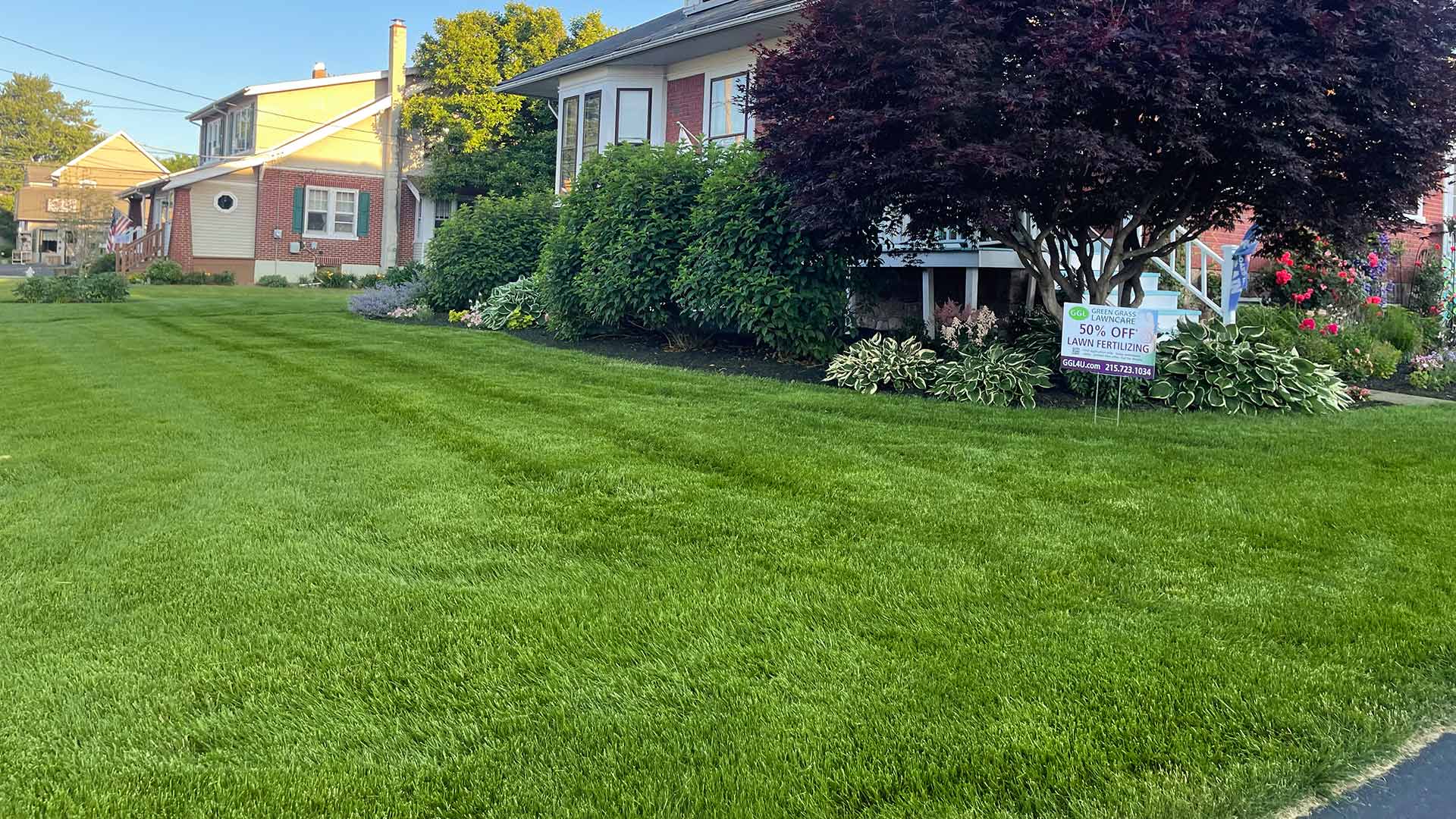Lush, green lawn in front of a home with landscaping in Newtown, PA.
