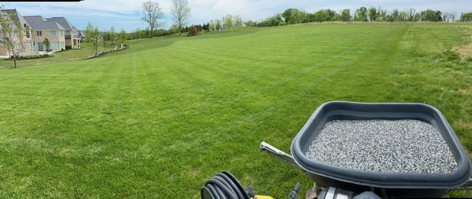 Overview of granular fertilizer spreader machine in lawn in Harleysville, PA.