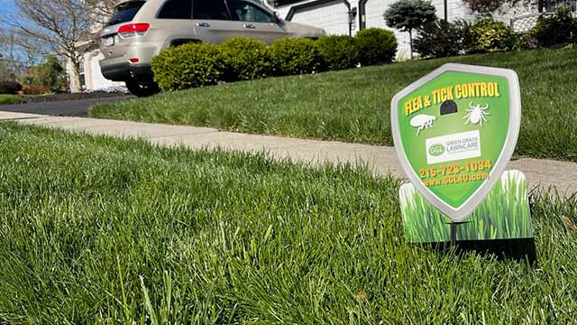 Lawn with a flea and tick control sign near Souderton, PA.