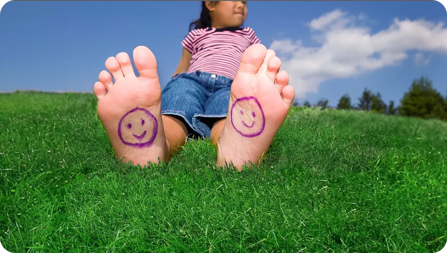 girl sitting in green healthy grass