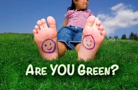 girl sitting in green healthy grass